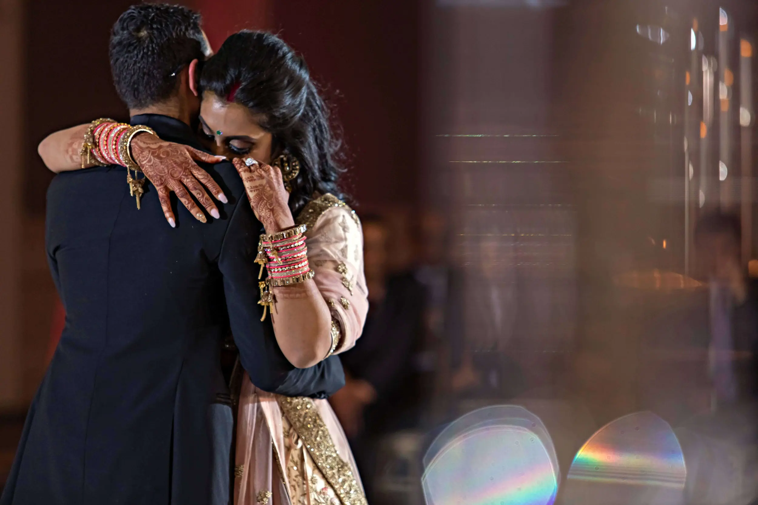 Bride embraces groom during emotional first dance at an Indian wedding in Atlanta