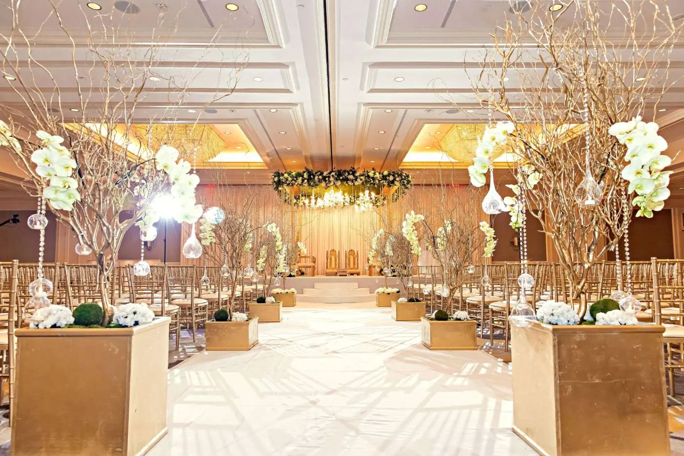 Luxury wedding aisle with gold planters and orchids leading to floral mandap at Indian wedding in Georgia