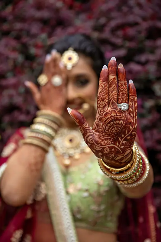 Close-up of intricate bridal mehndi and engagement ring during fusion wedding preparations in Atlanta